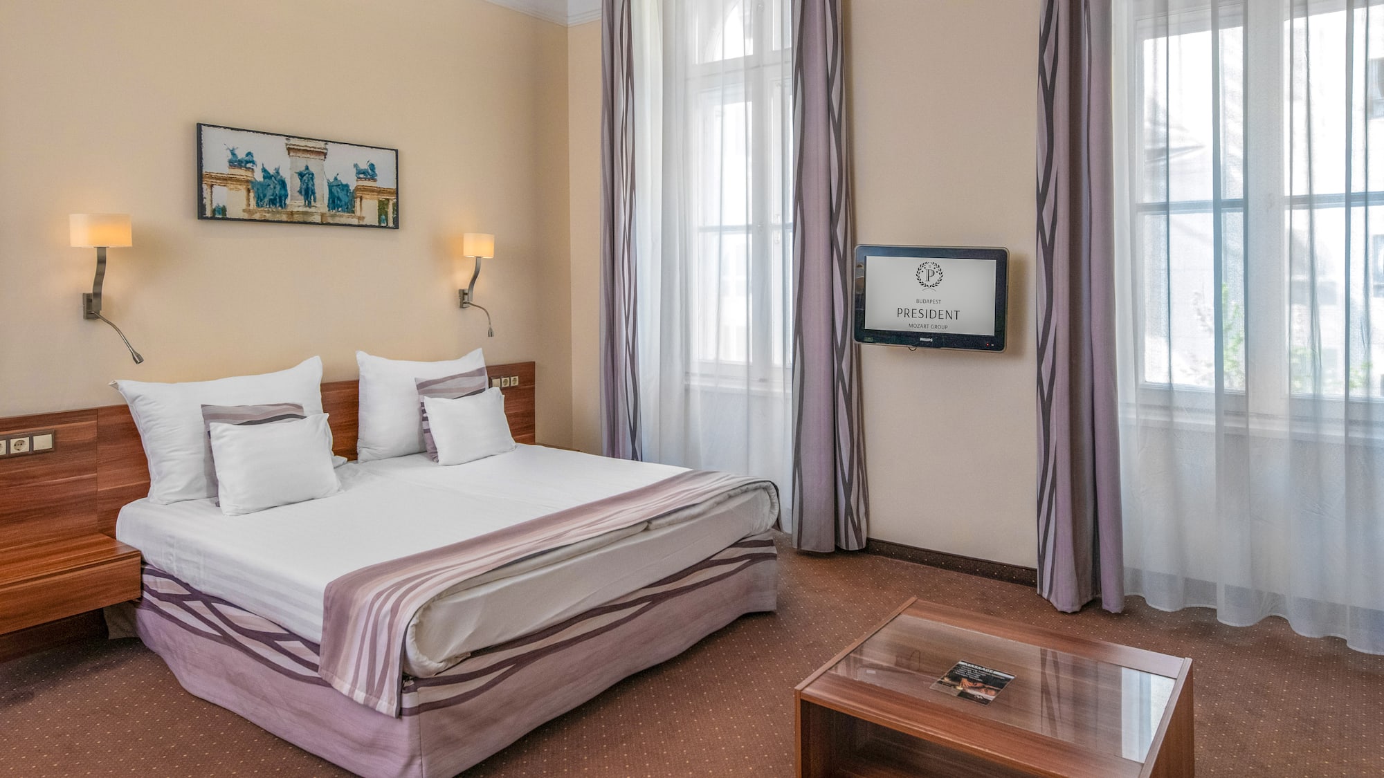 a room with a bed and a television