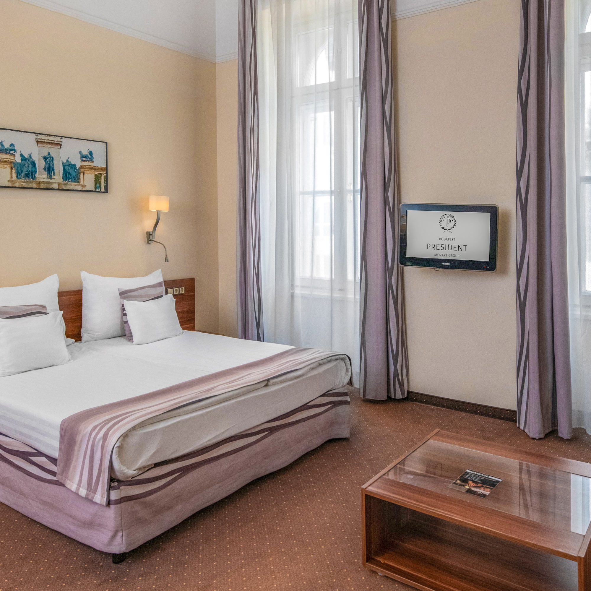 a room with a bed and a television