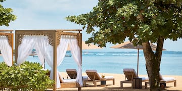 a beach with chairs and umbrellas