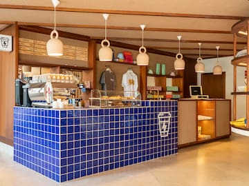 a counter with blue tiles and white lights