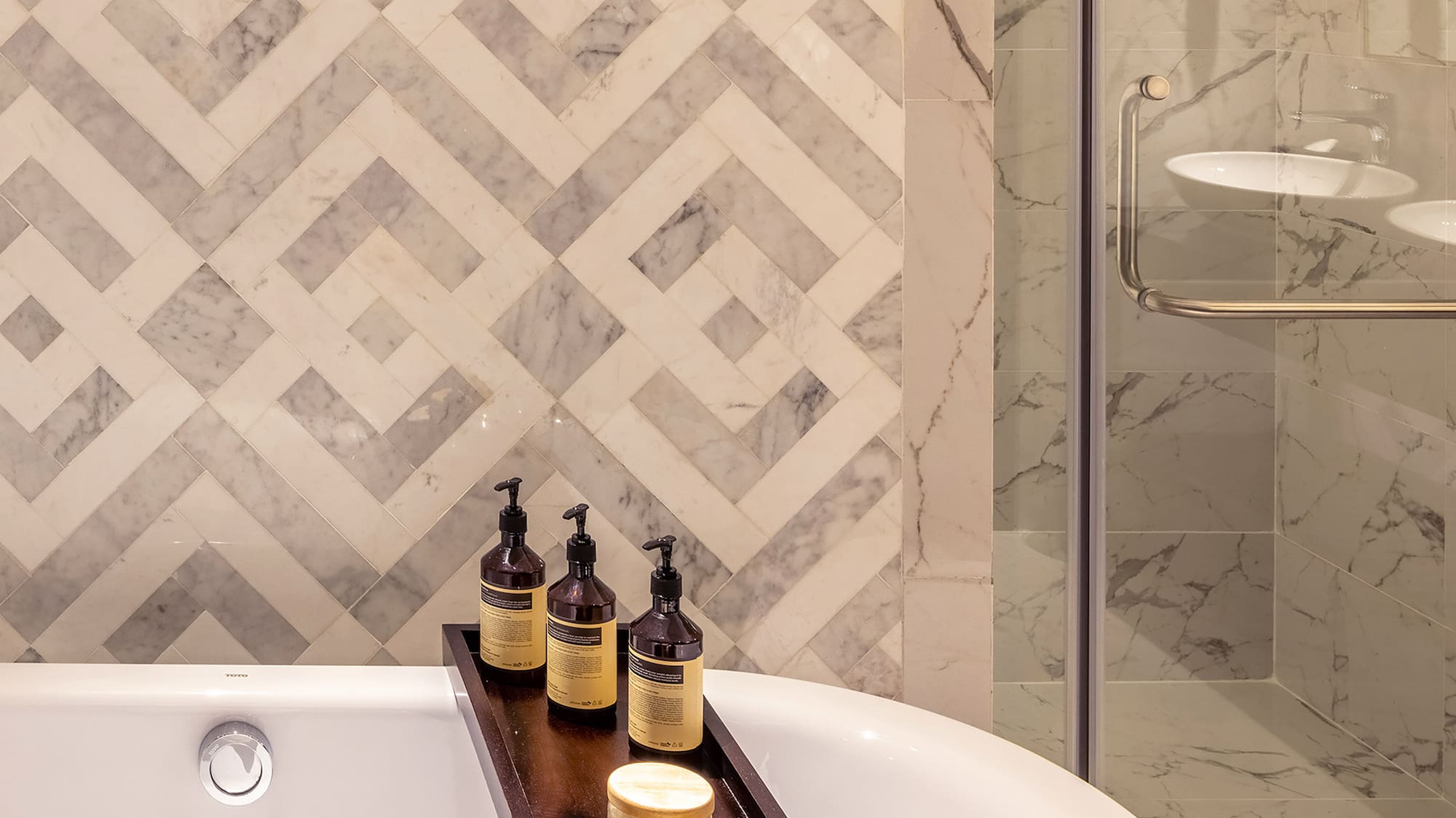 a bathtub with candles and soap on a tray