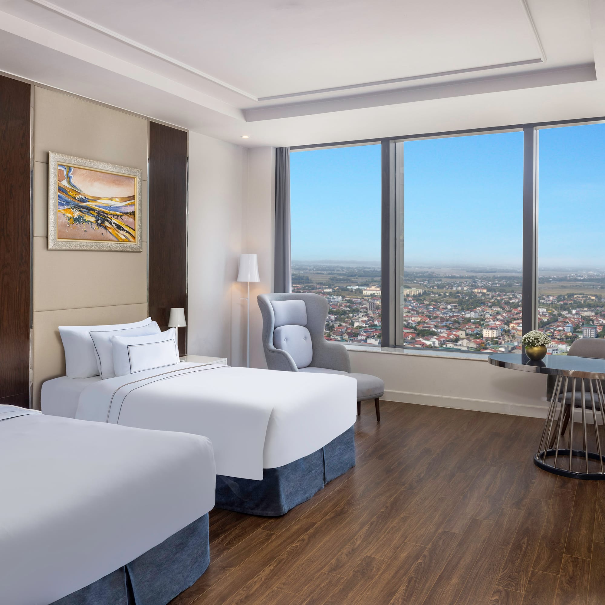 a room with two beds and a table and chairs