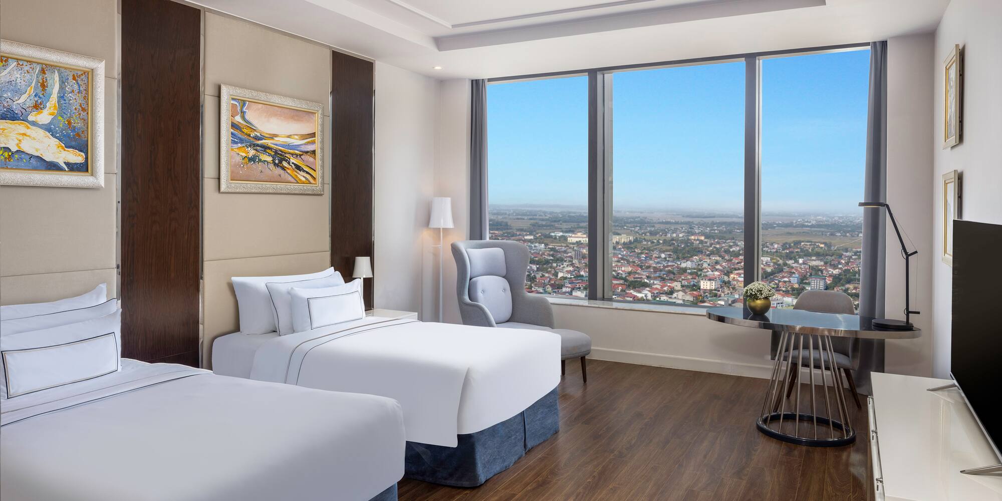 a room with two beds and a table and chairs