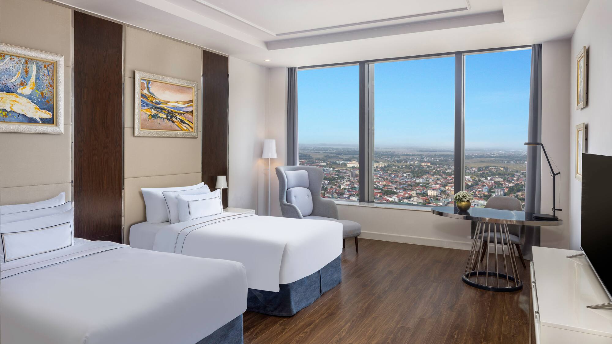 a room with two beds and a table and chairs