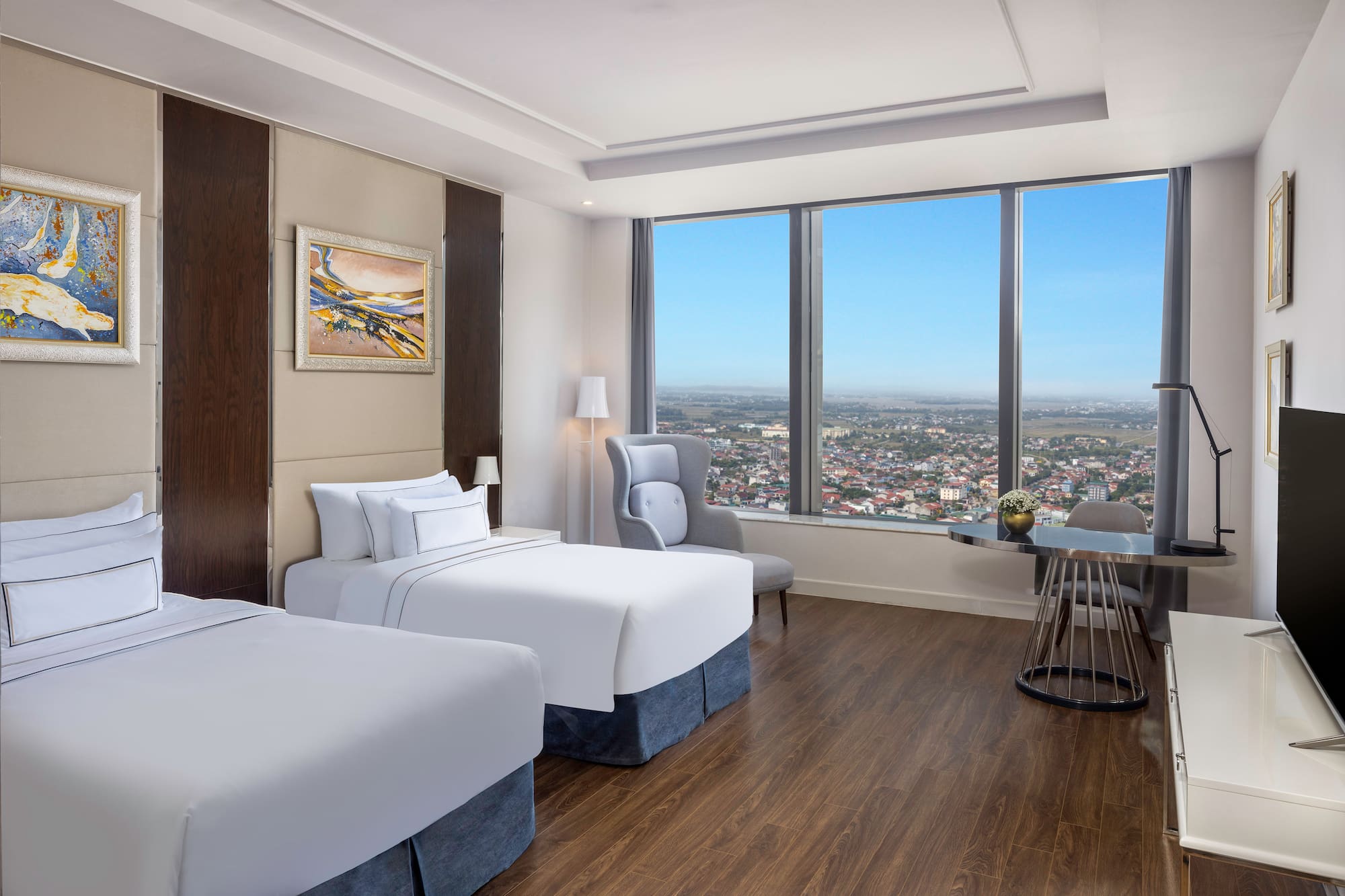 a room with two beds and a table and chairs