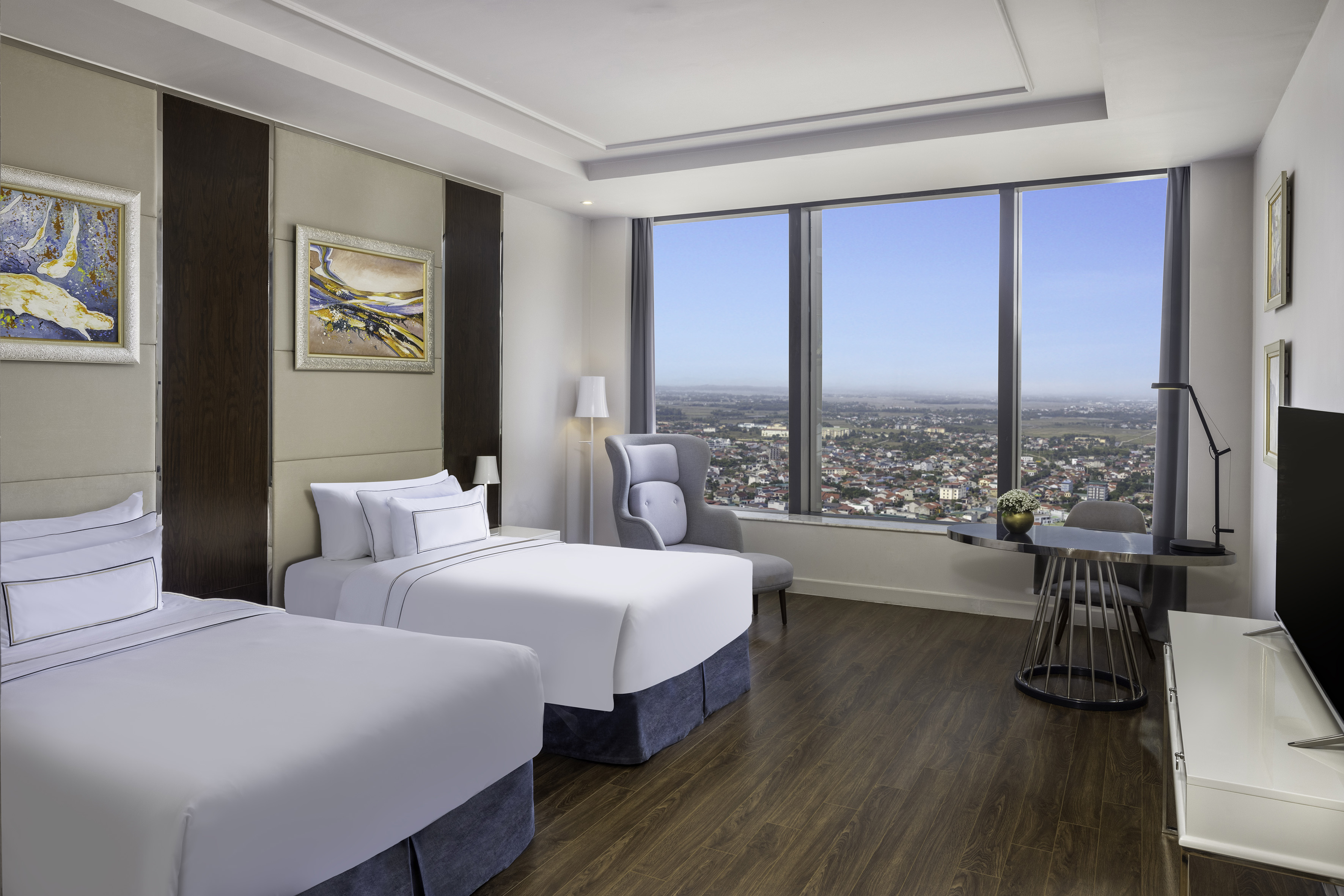 a room with two beds and a table and chairs