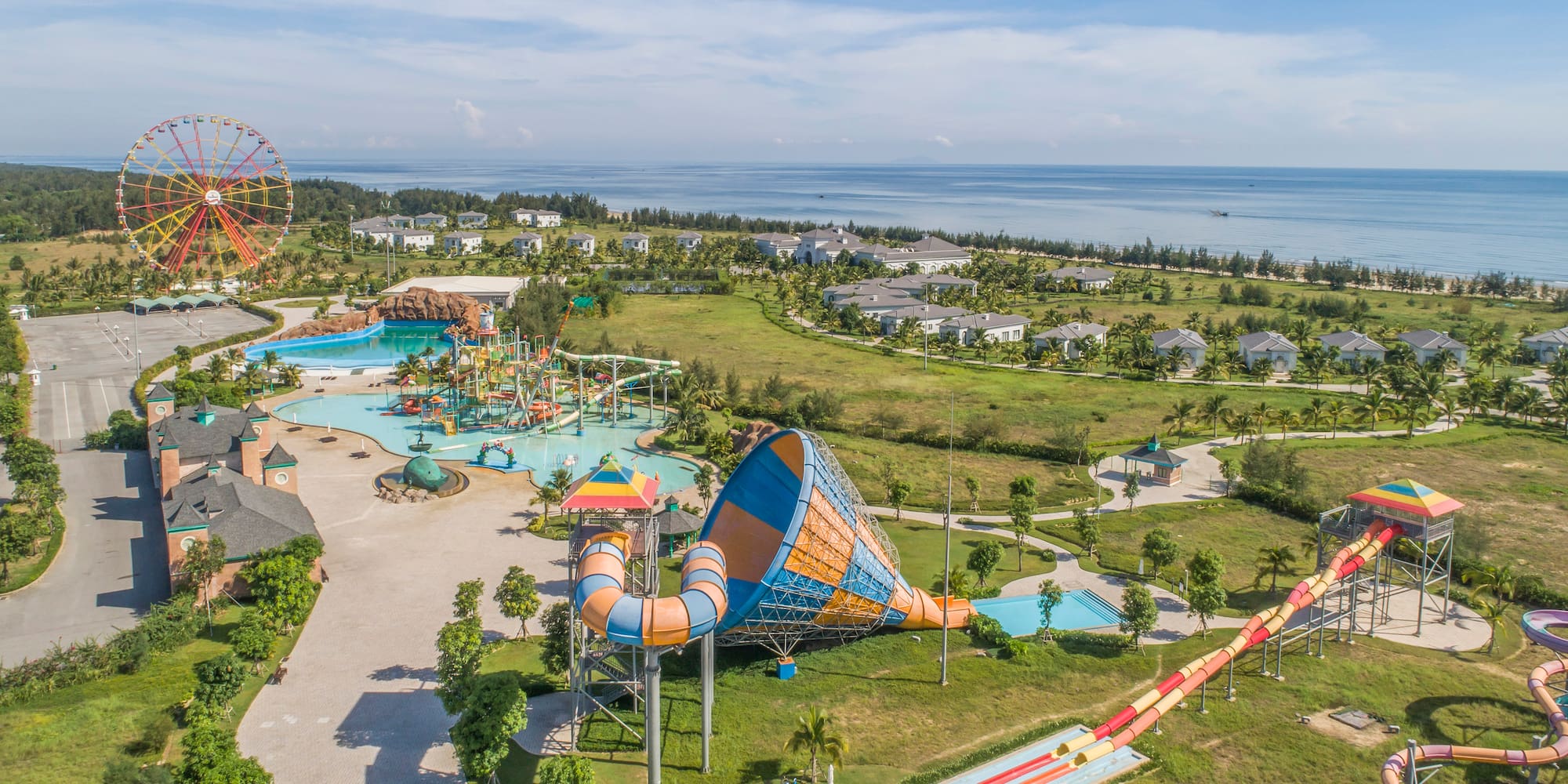 an amusement park with a water slide and a beach