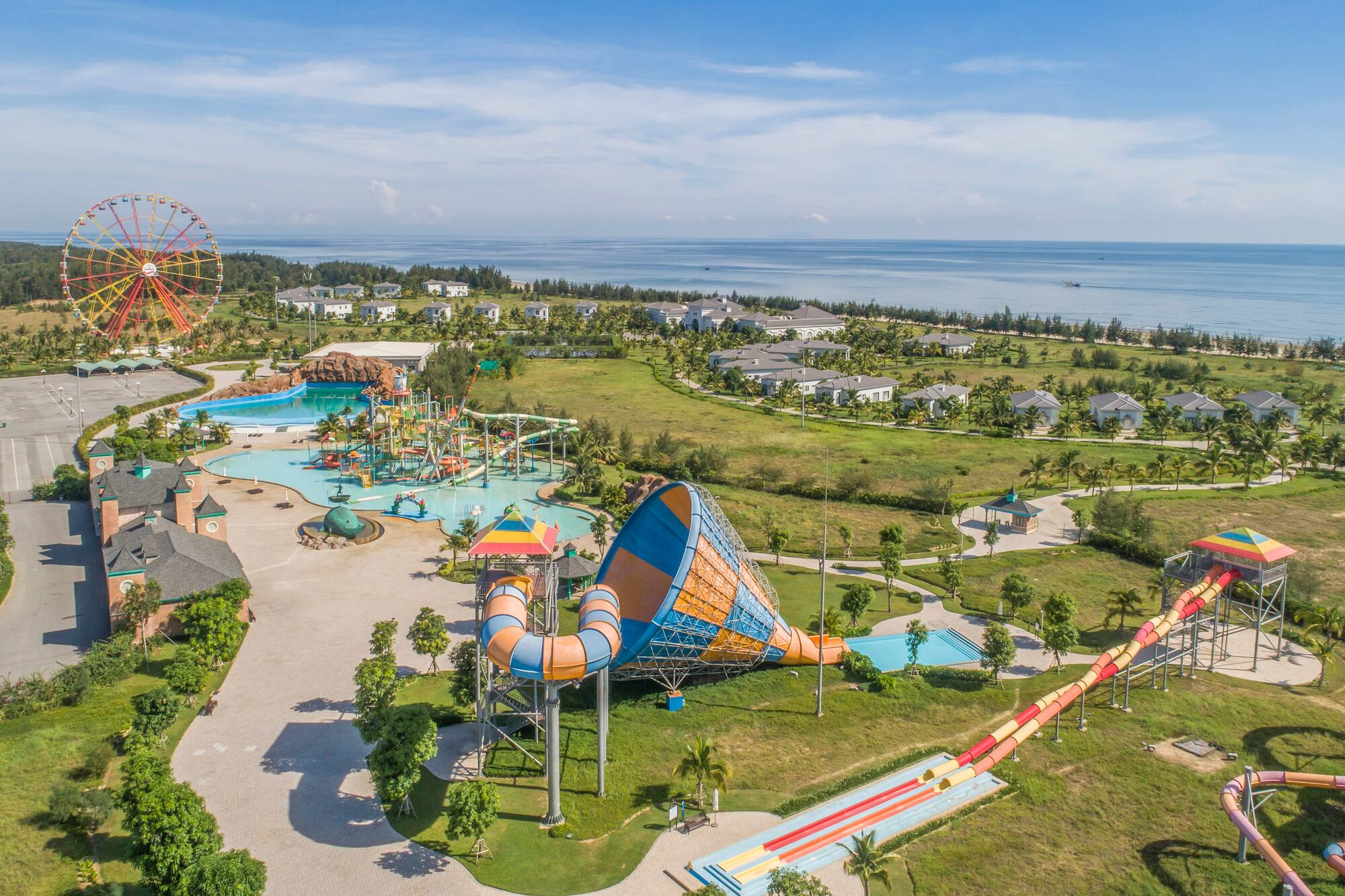 an amusement park with a water slide and a beach