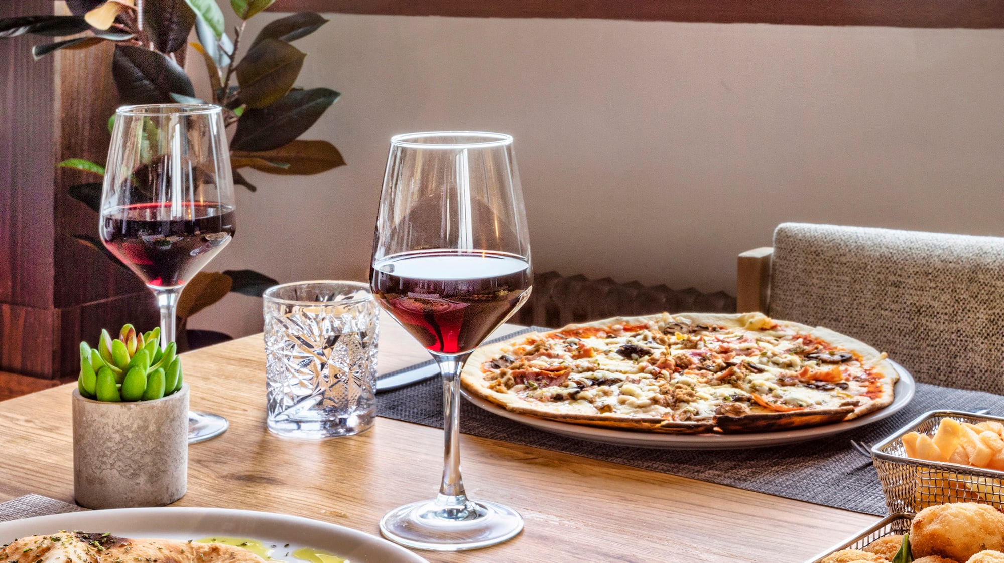 a table with food and wine glasses