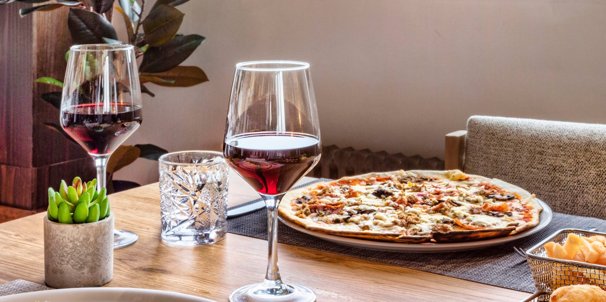 a table with food and wine glasses