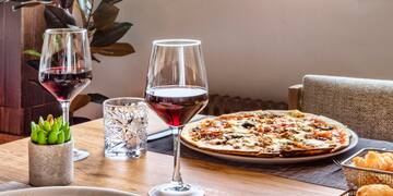 a table with food and wine glasses