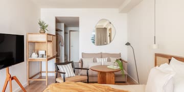 a bedroom with a bed and a couch