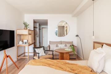 a bedroom with a bed and a couch