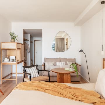 a bedroom with a bed and a couch