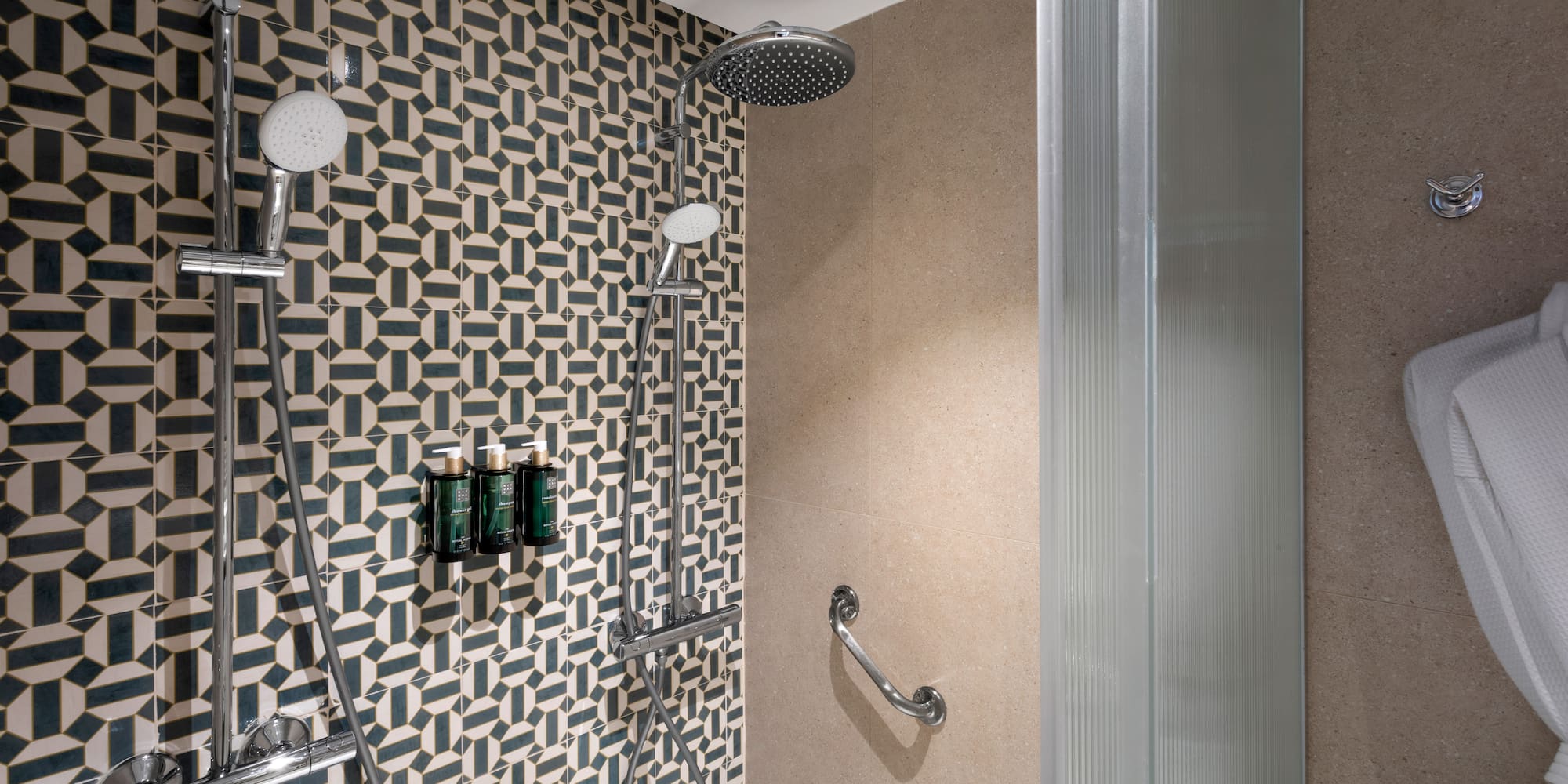 a shower with a wall and shower head