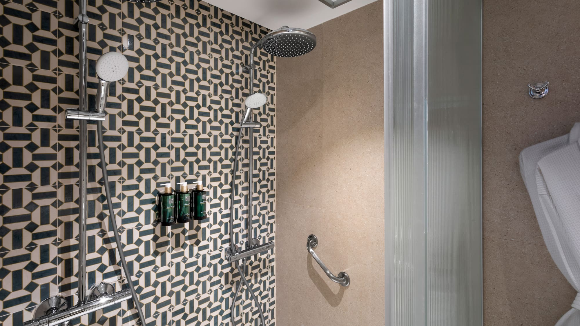 a shower with a wall and shower head