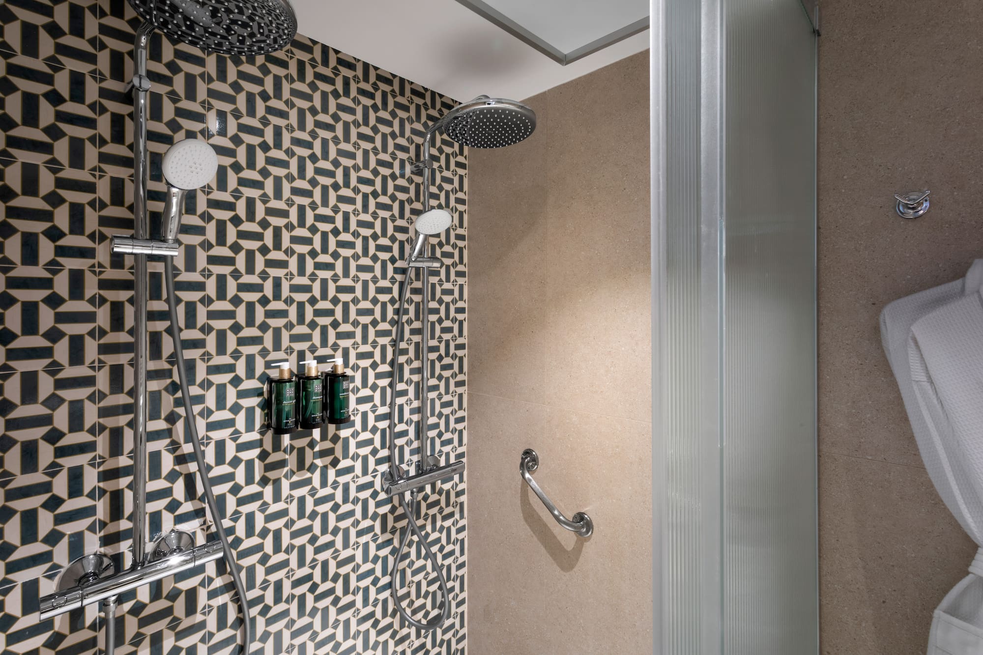 a shower with a wall and shower head