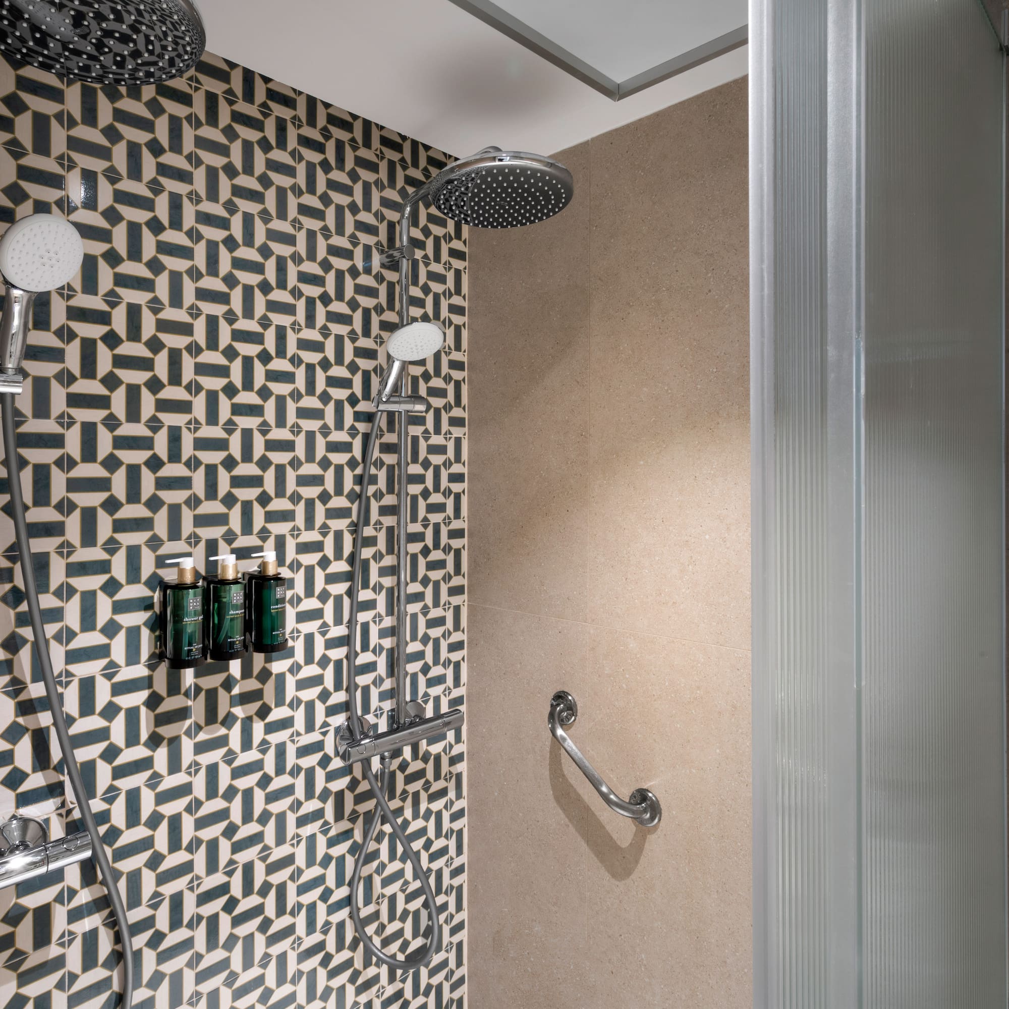 a shower with a wall and shower head