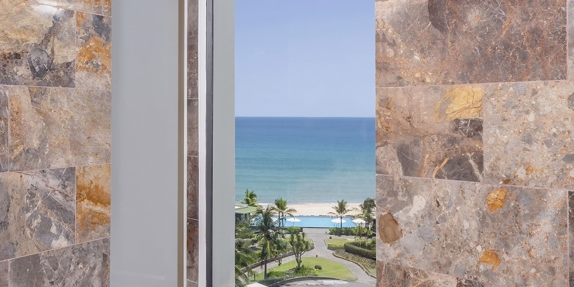 a bathroom with a tub and a view of the ocean