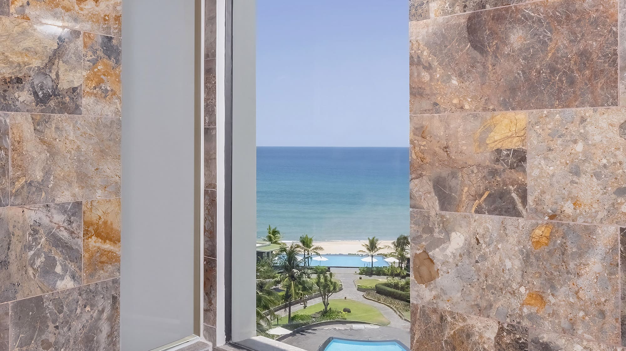 a bathroom with a tub and a view of the ocean