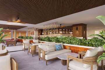 a room with a bar and chairs