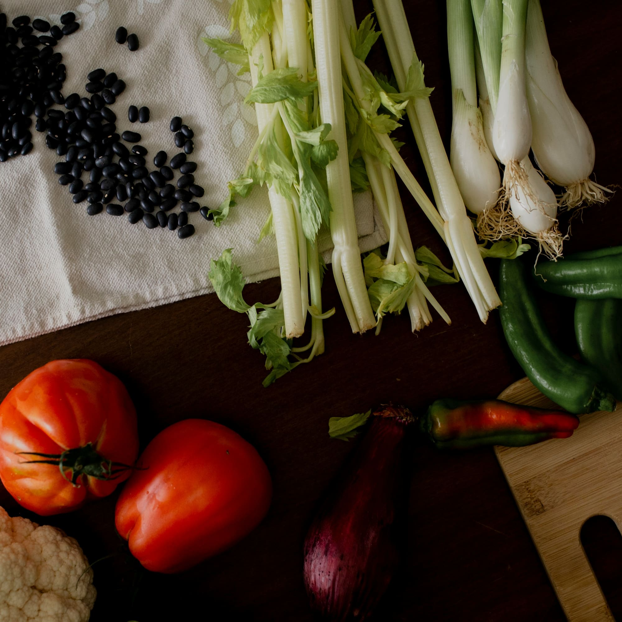 Healthy fresh vegetables, black beans, celery, tomatoes, peppers for cooking.