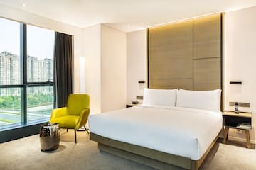 a bedroom with a bed and a chair