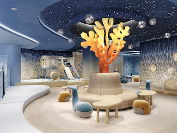 a room with a large tree and a playground