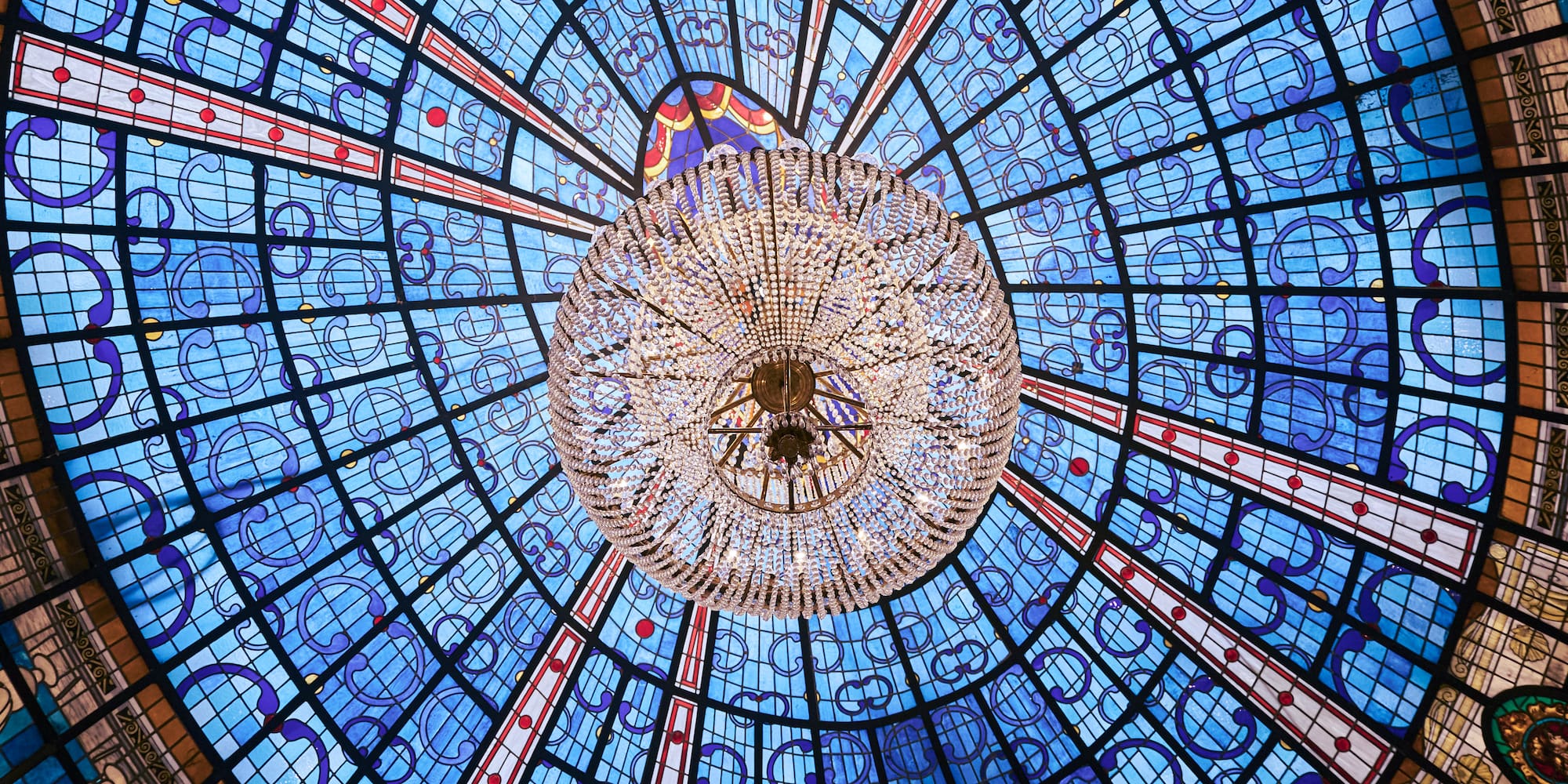 a chandelier in a blue and red ceiling