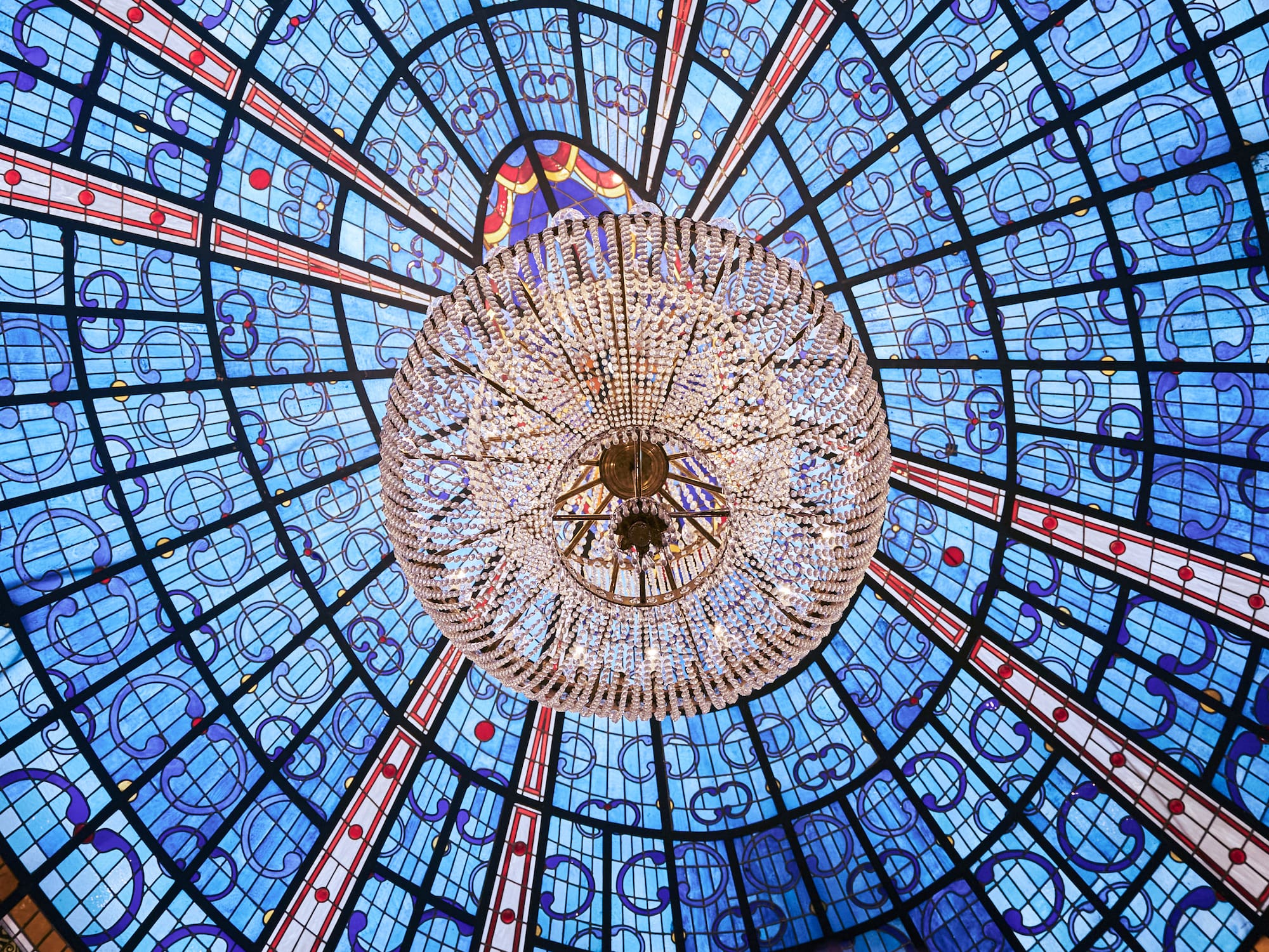a chandelier in a blue and red ceiling