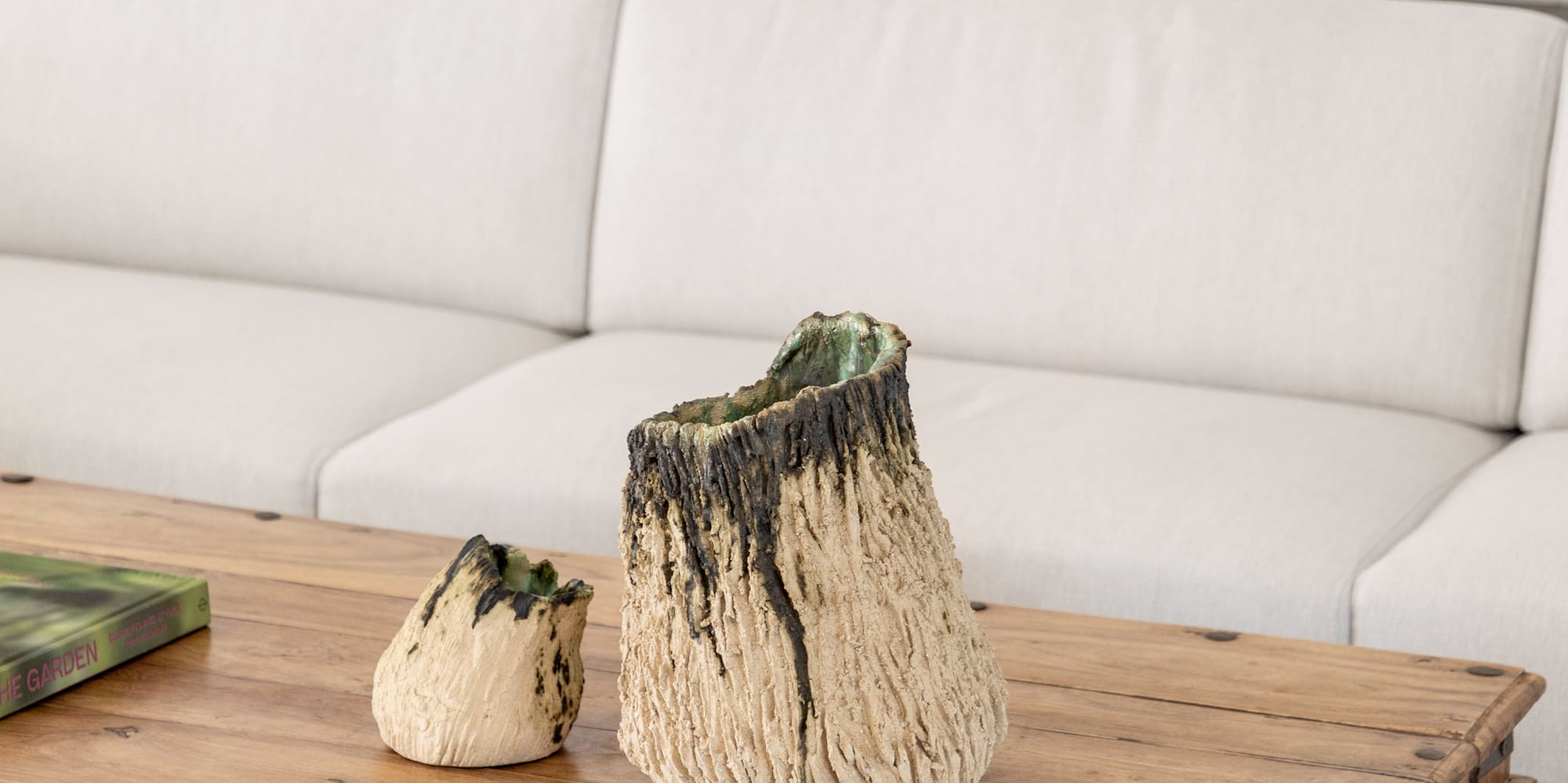 a table with a white couch and a white wall behind it