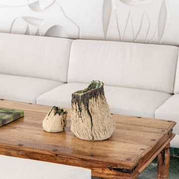 a table with a white couch and a white wall behind it