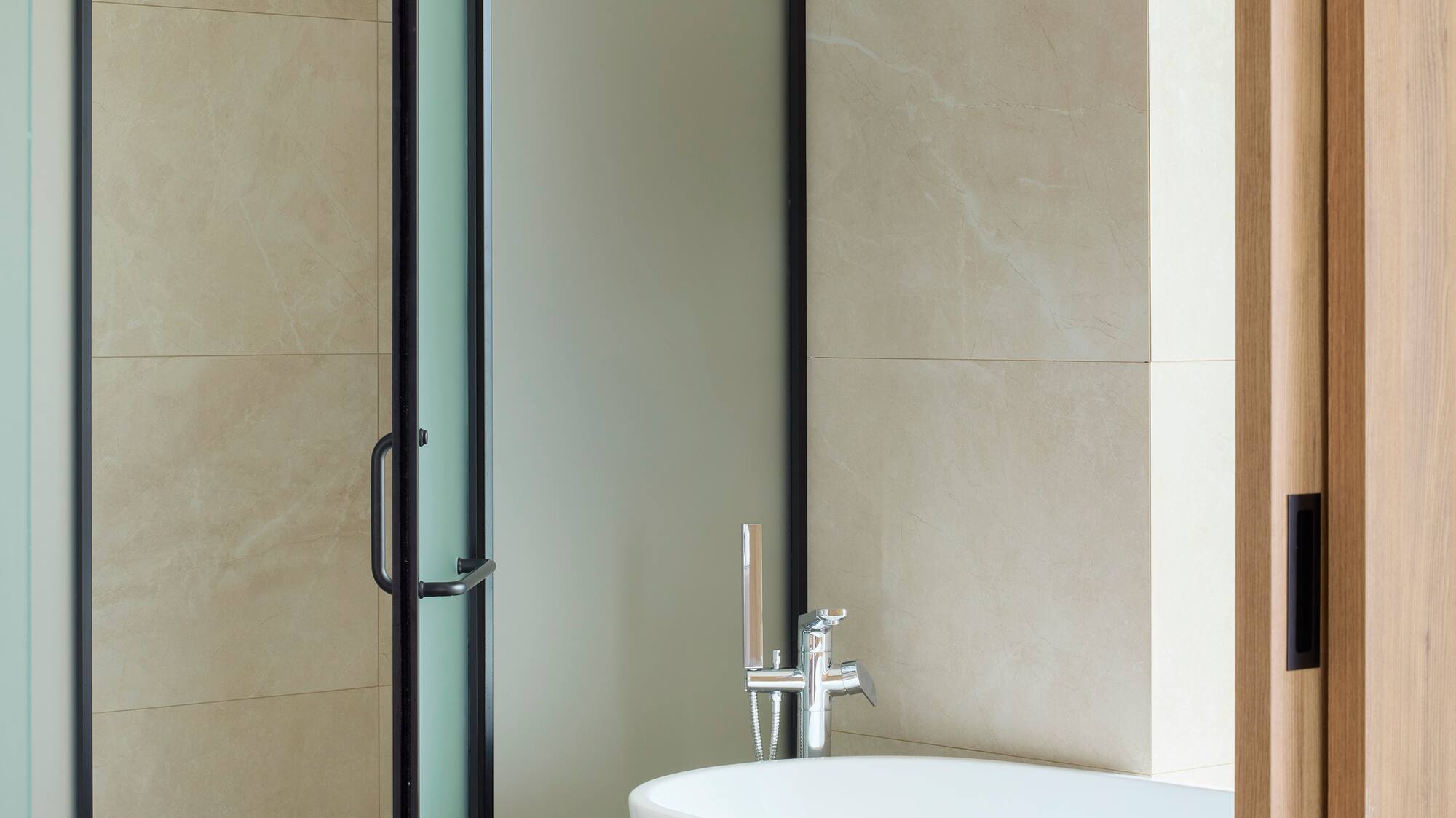 a bathroom with a glass shower door
