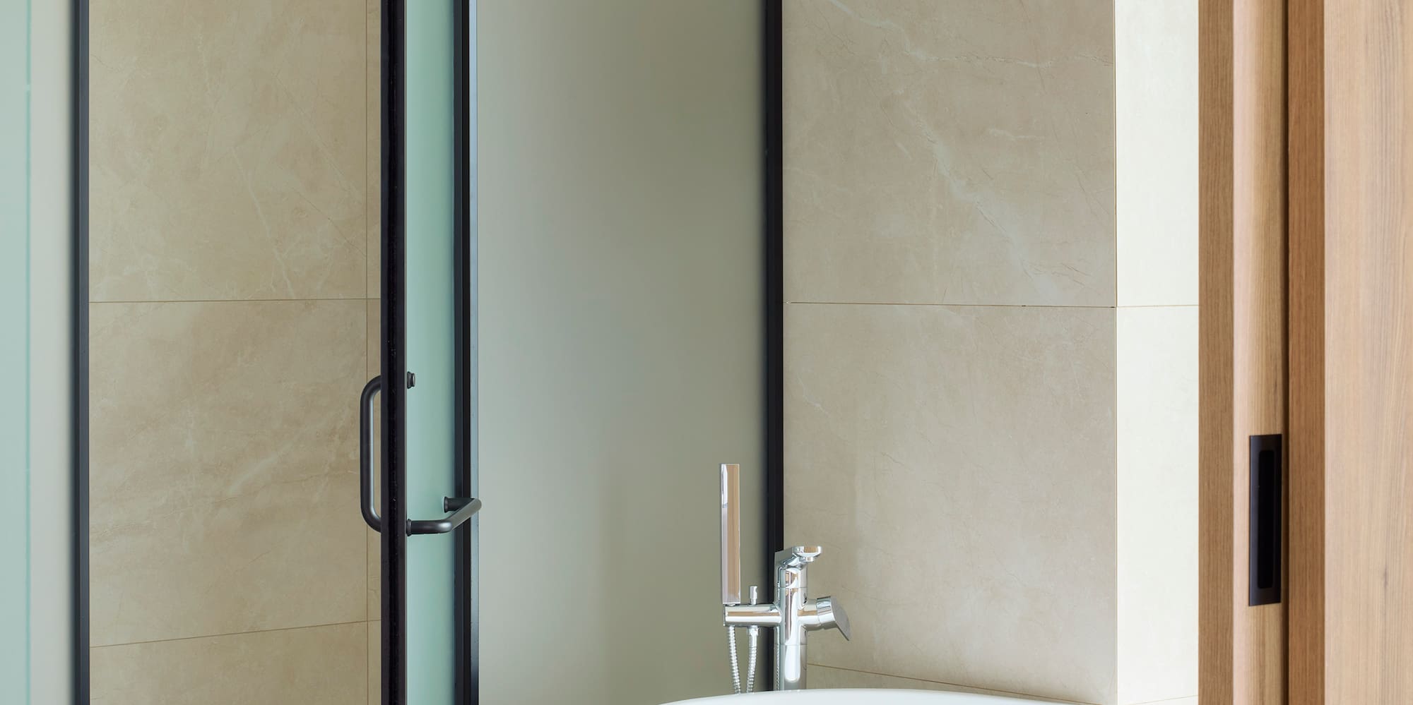 a bathroom with a glass shower door