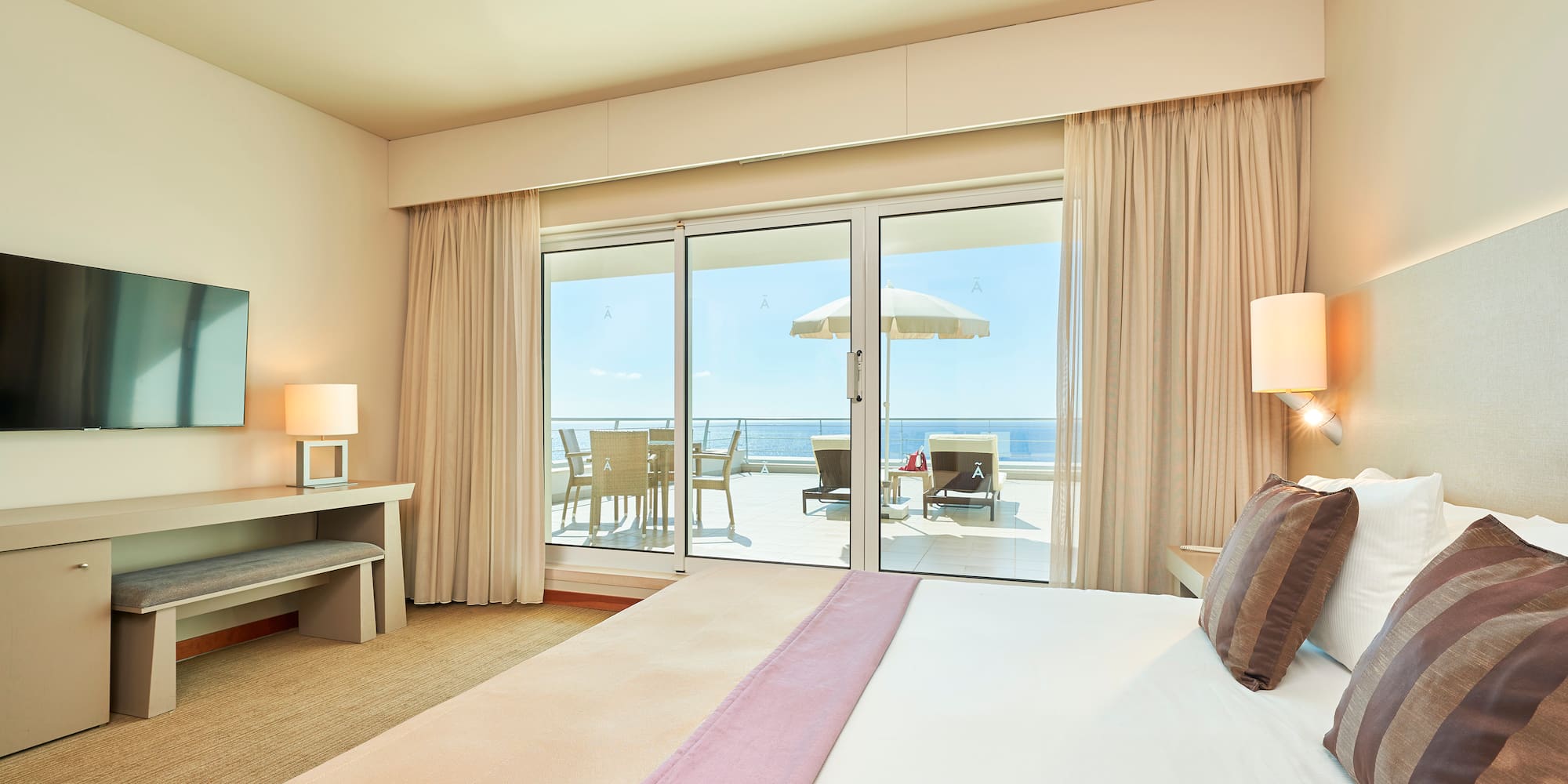 a bedroom with a large bed and a glass door