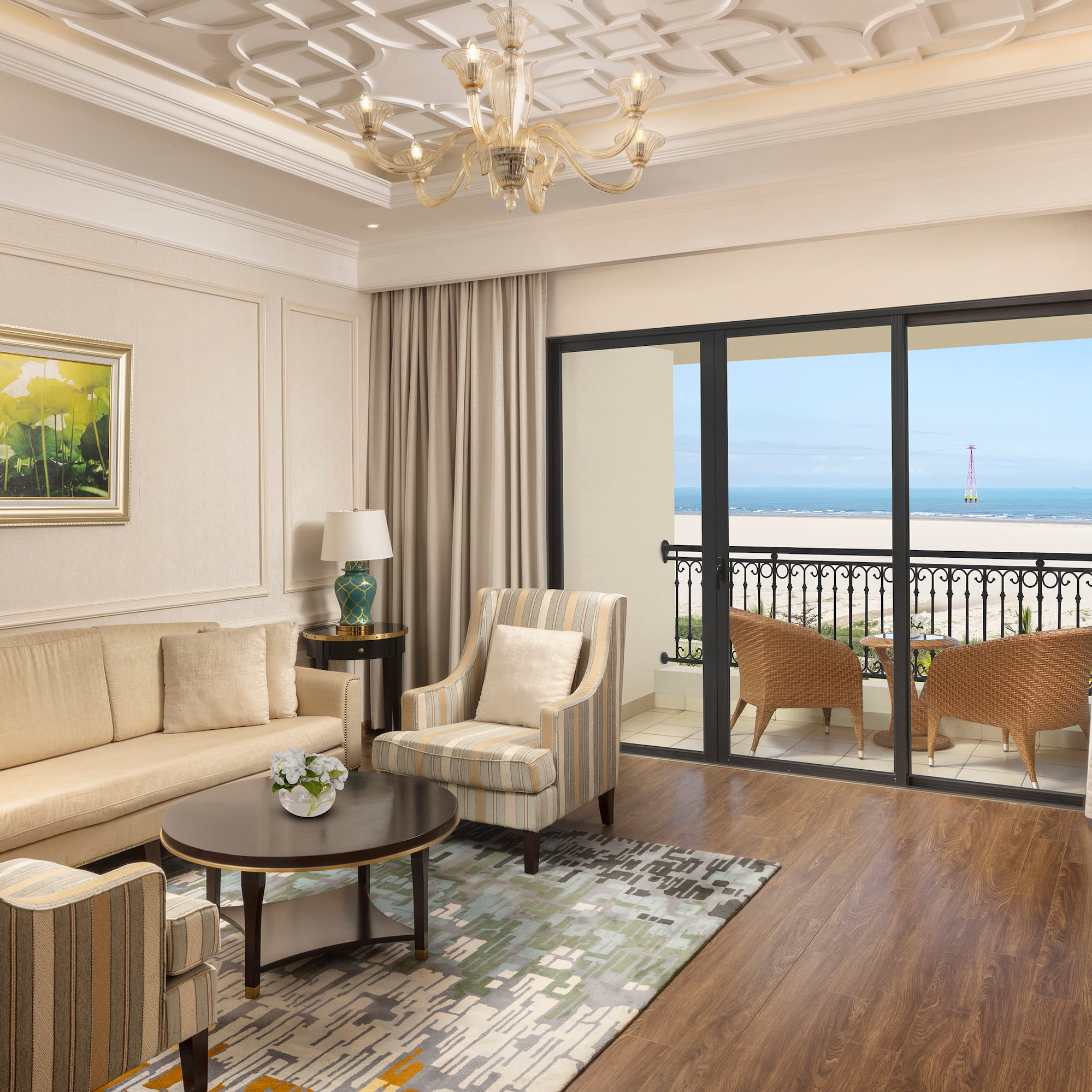 a living room with a balcony overlooking the ocean