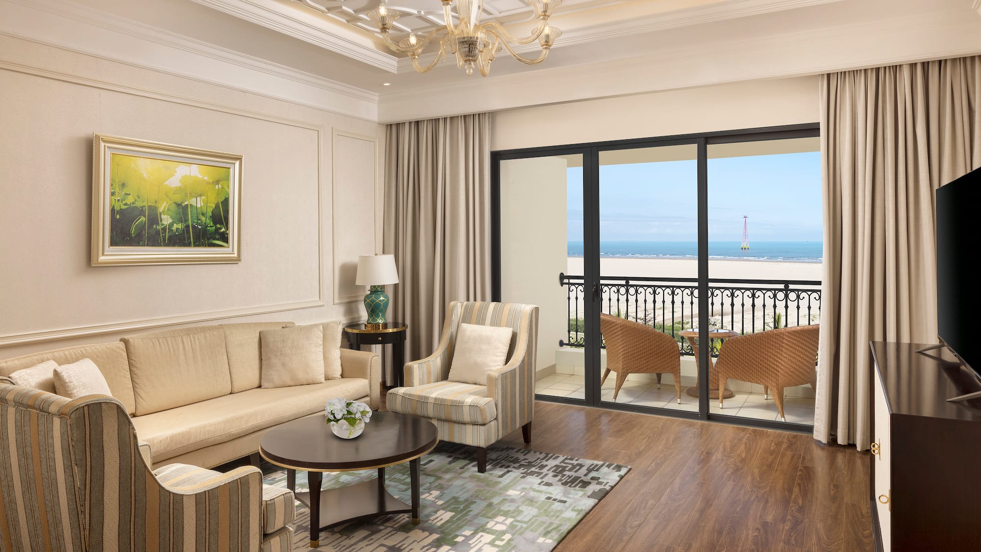 a living room with a balcony overlooking the ocean