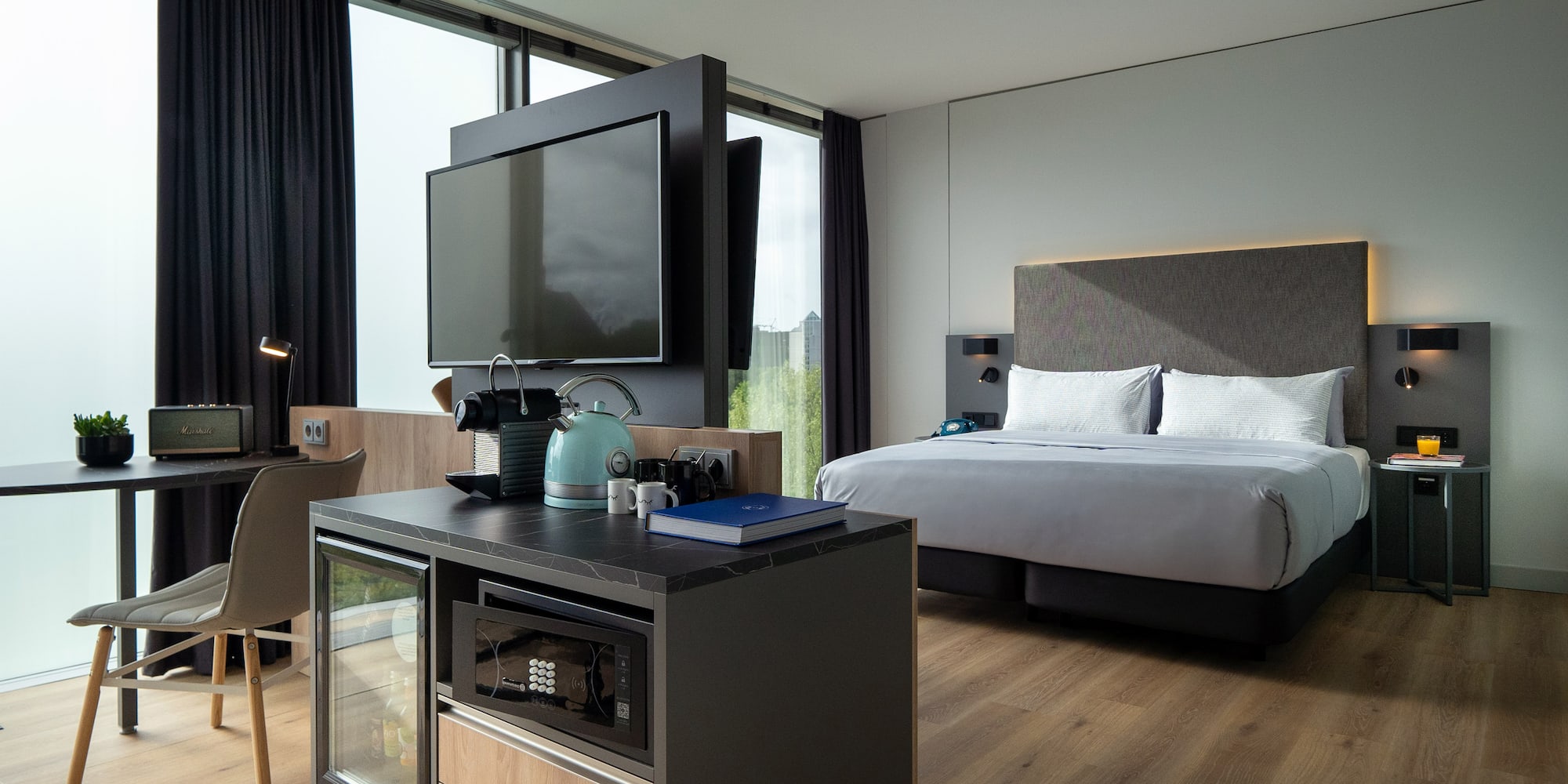 a room with a bed and a television