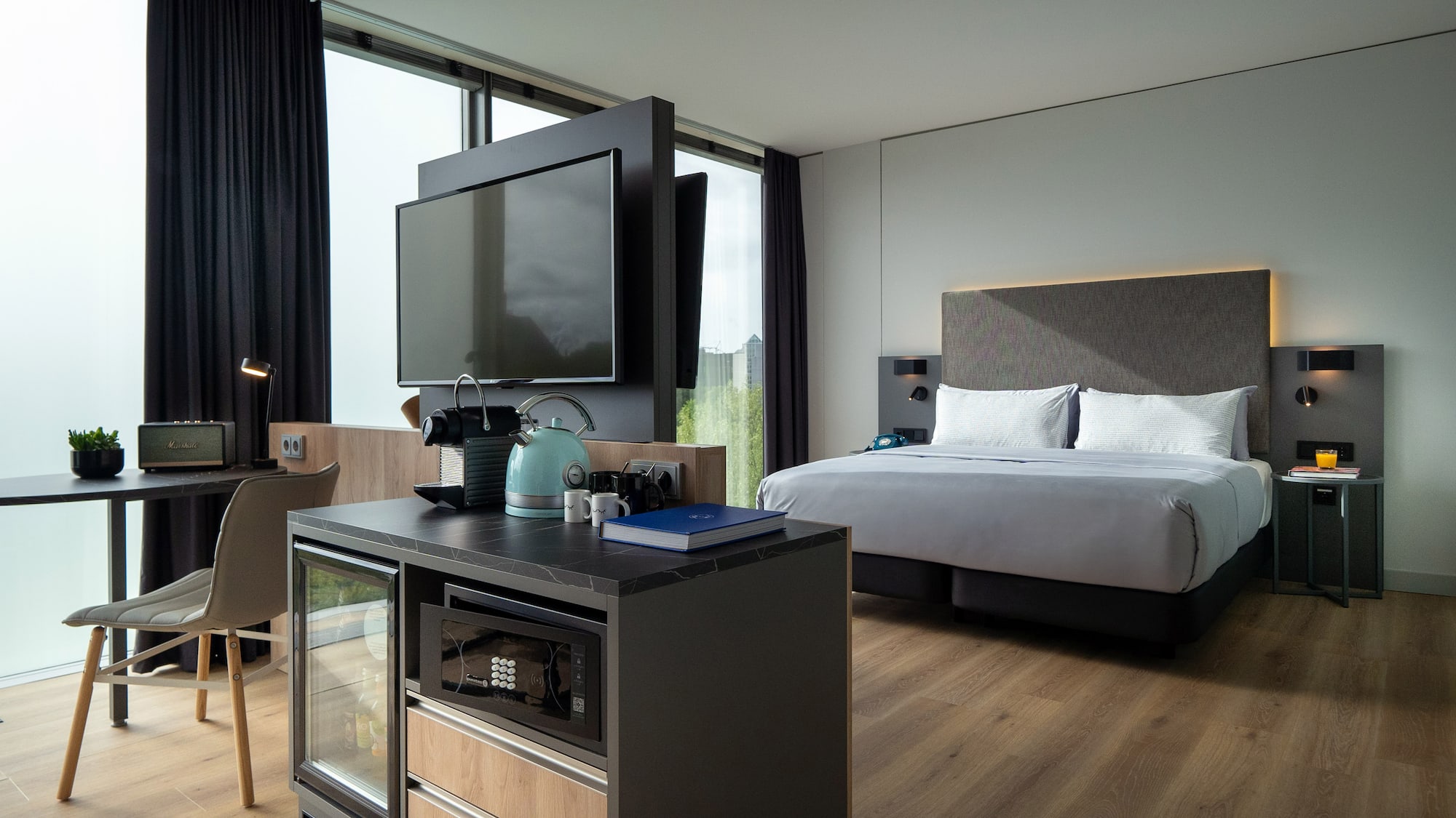 a room with a bed and a television