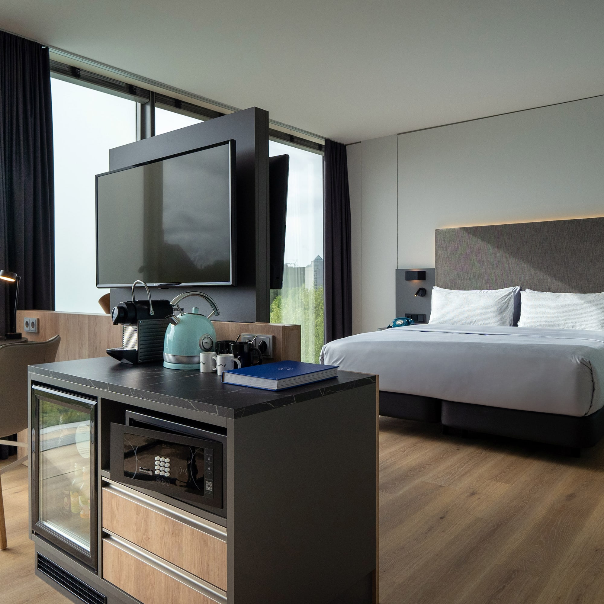 a room with a bed and a television