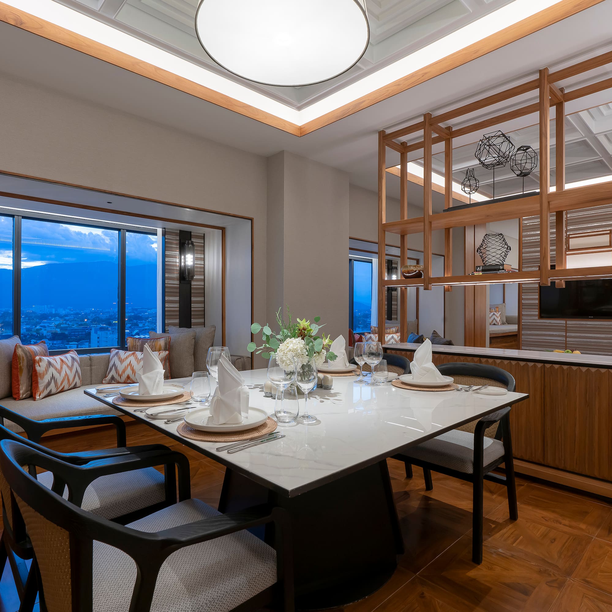 a dining table with chairs and a large window