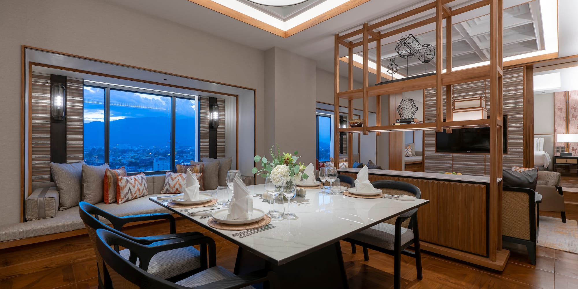 a dining table with chairs and a large window