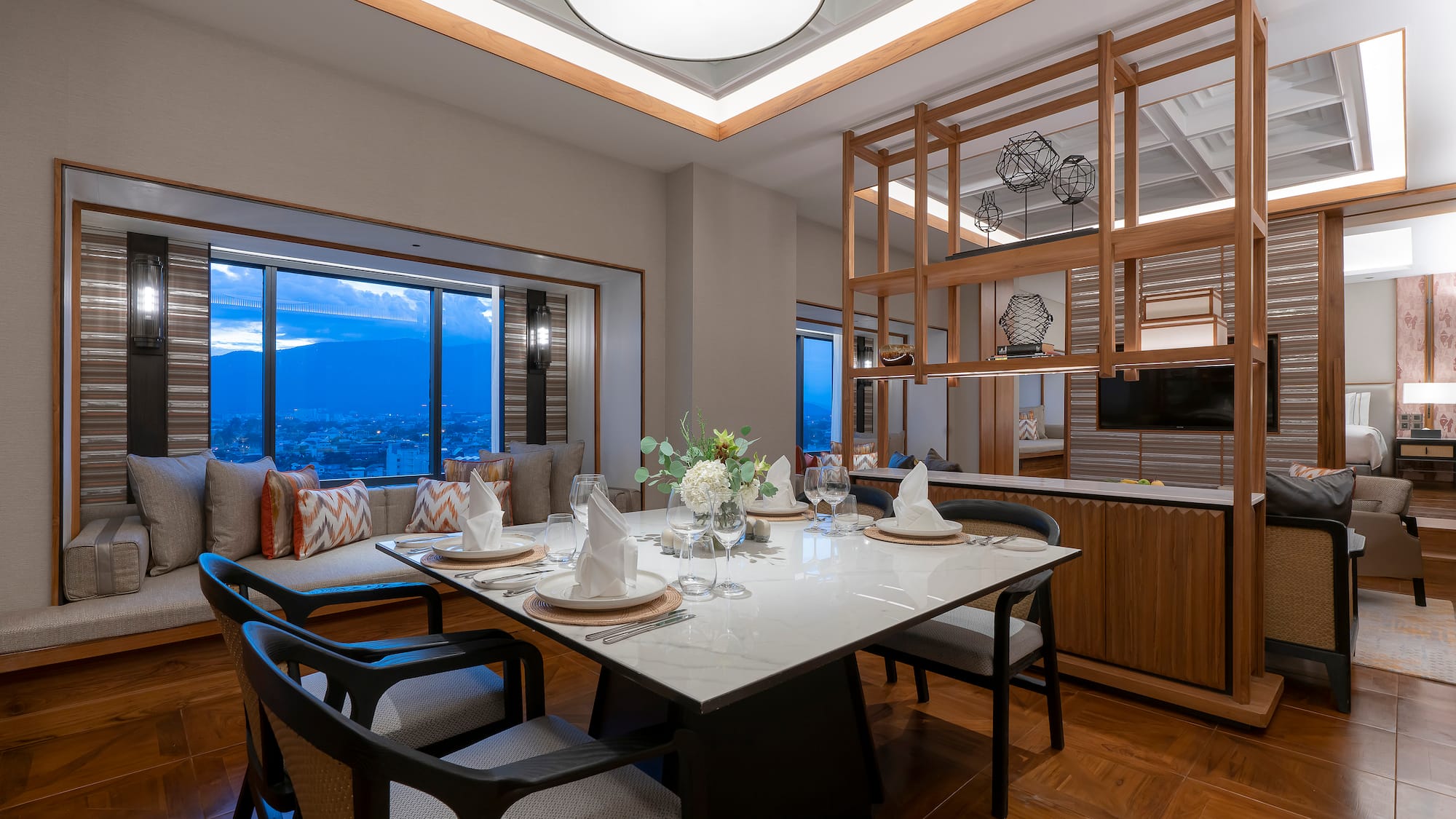 a dining table with chairs and a large window
