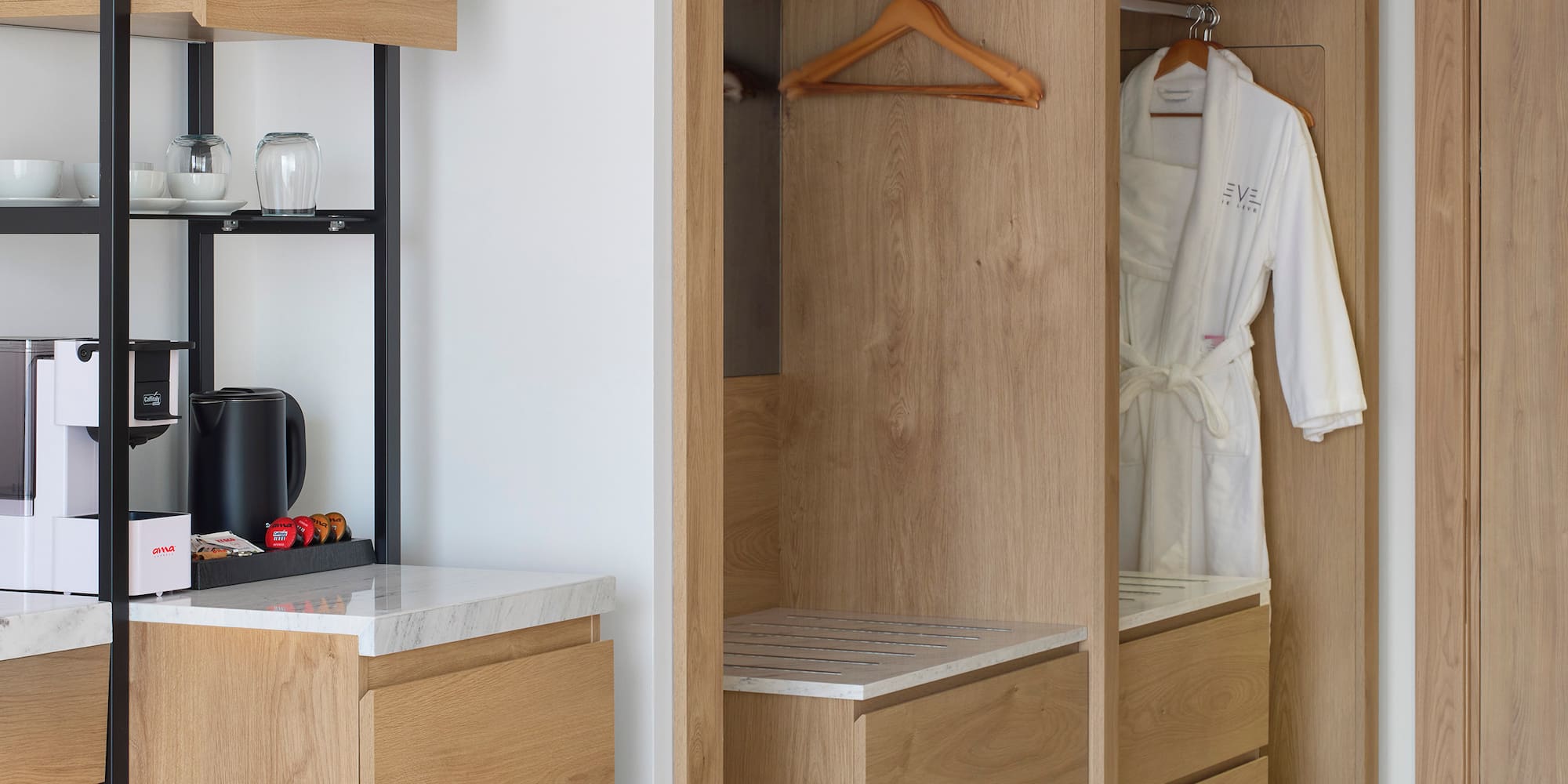 a room with a white robe and a black shelf