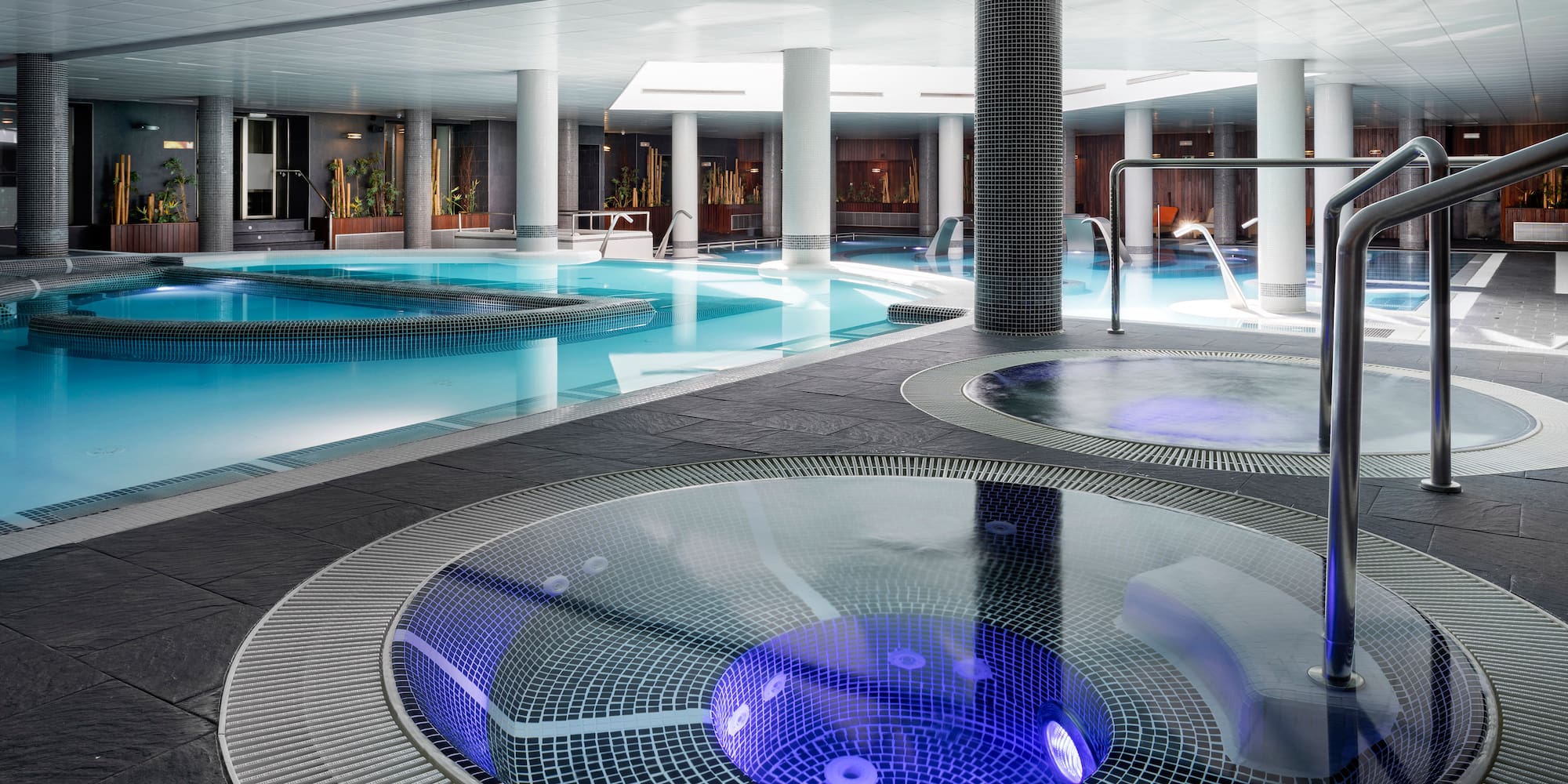 a swimming pool with a round jacuzzi