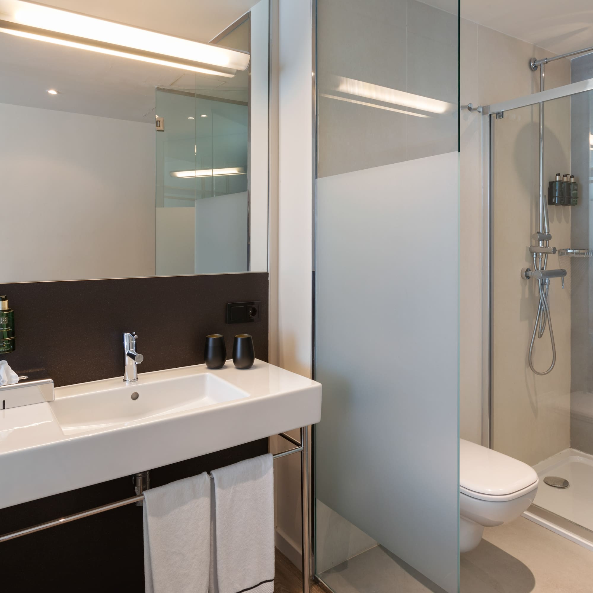 a bathroom with a shower and sink