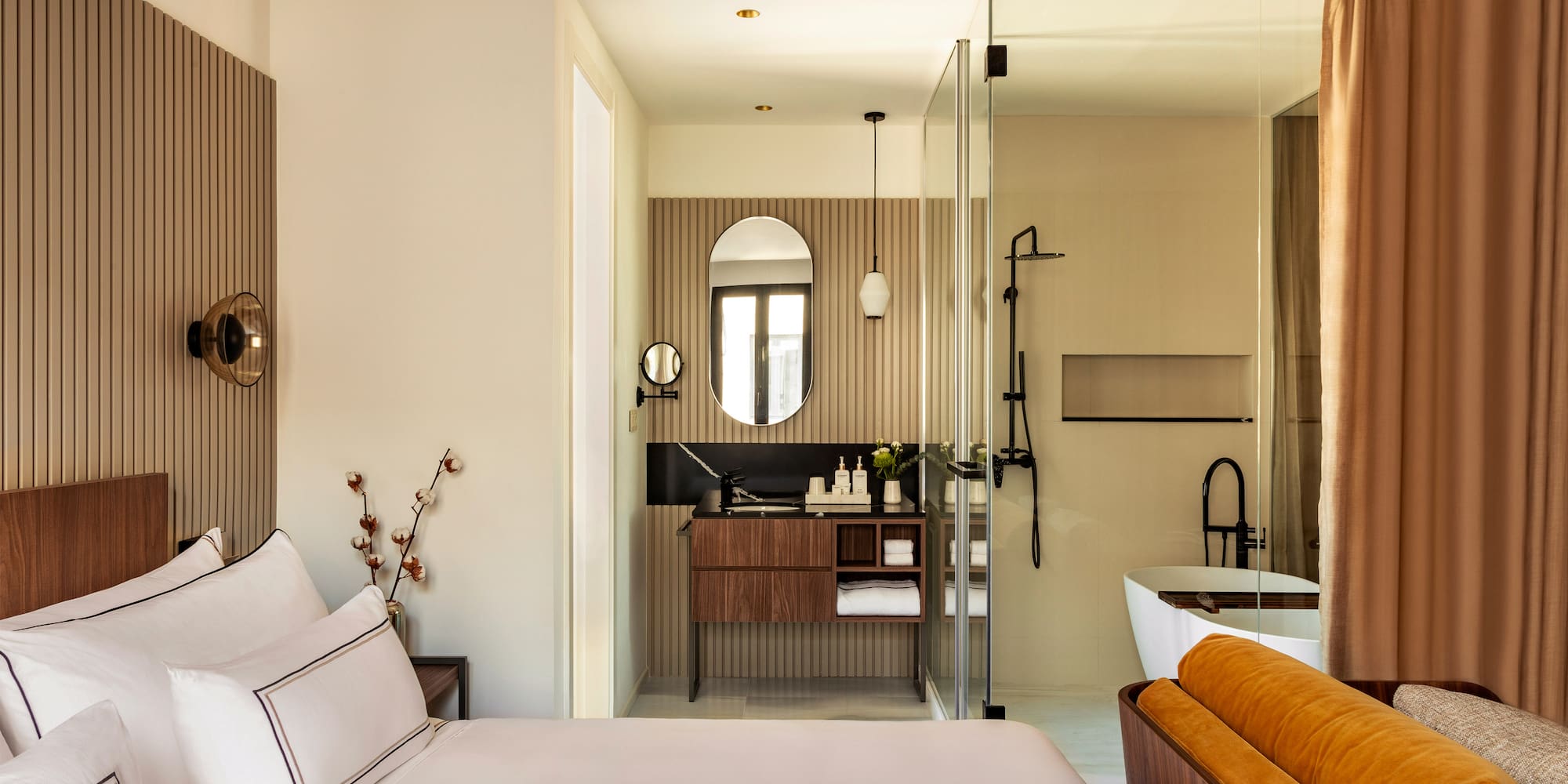 a bedroom with a glass shower door and a bed