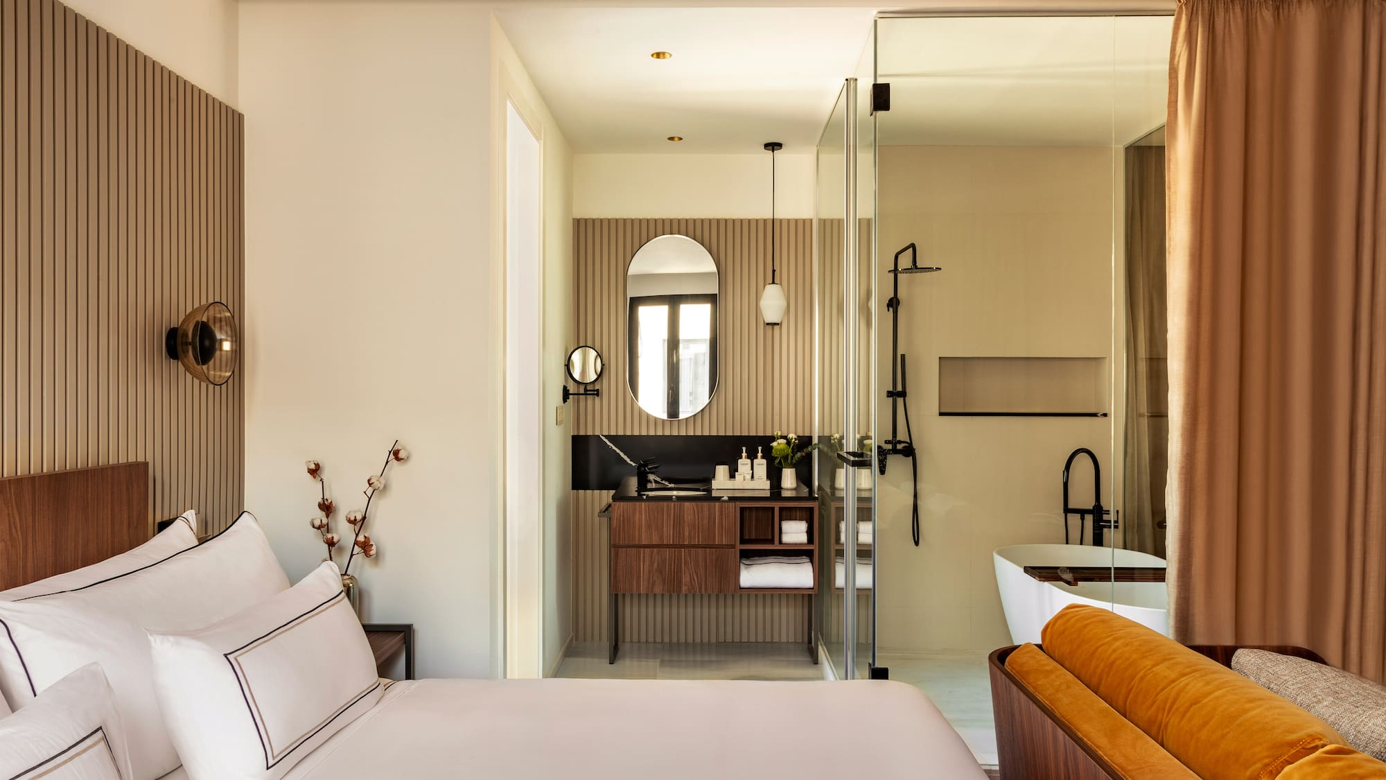 a bedroom with a glass shower door and a bed