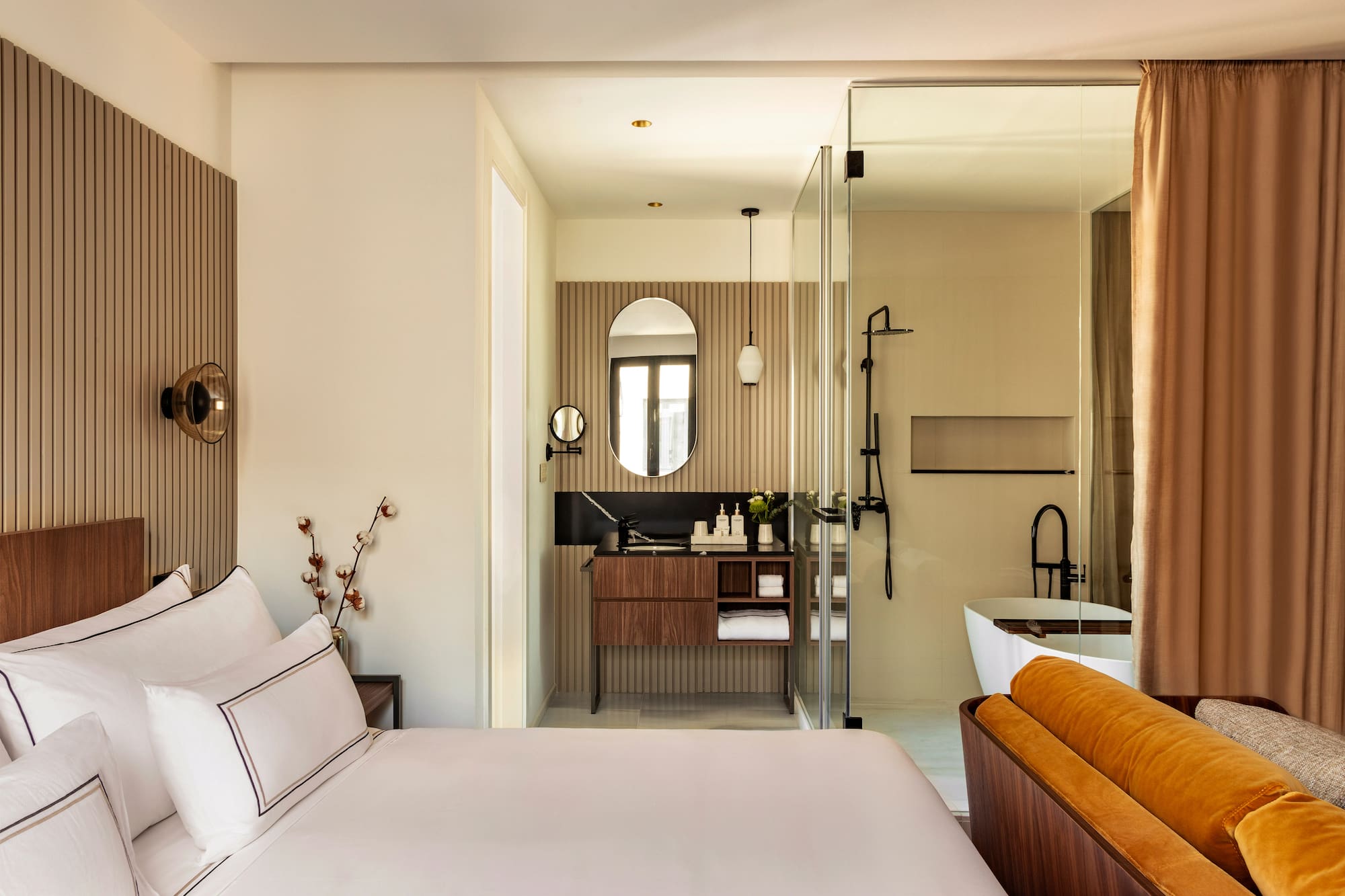 a bedroom with a glass shower door and a bed