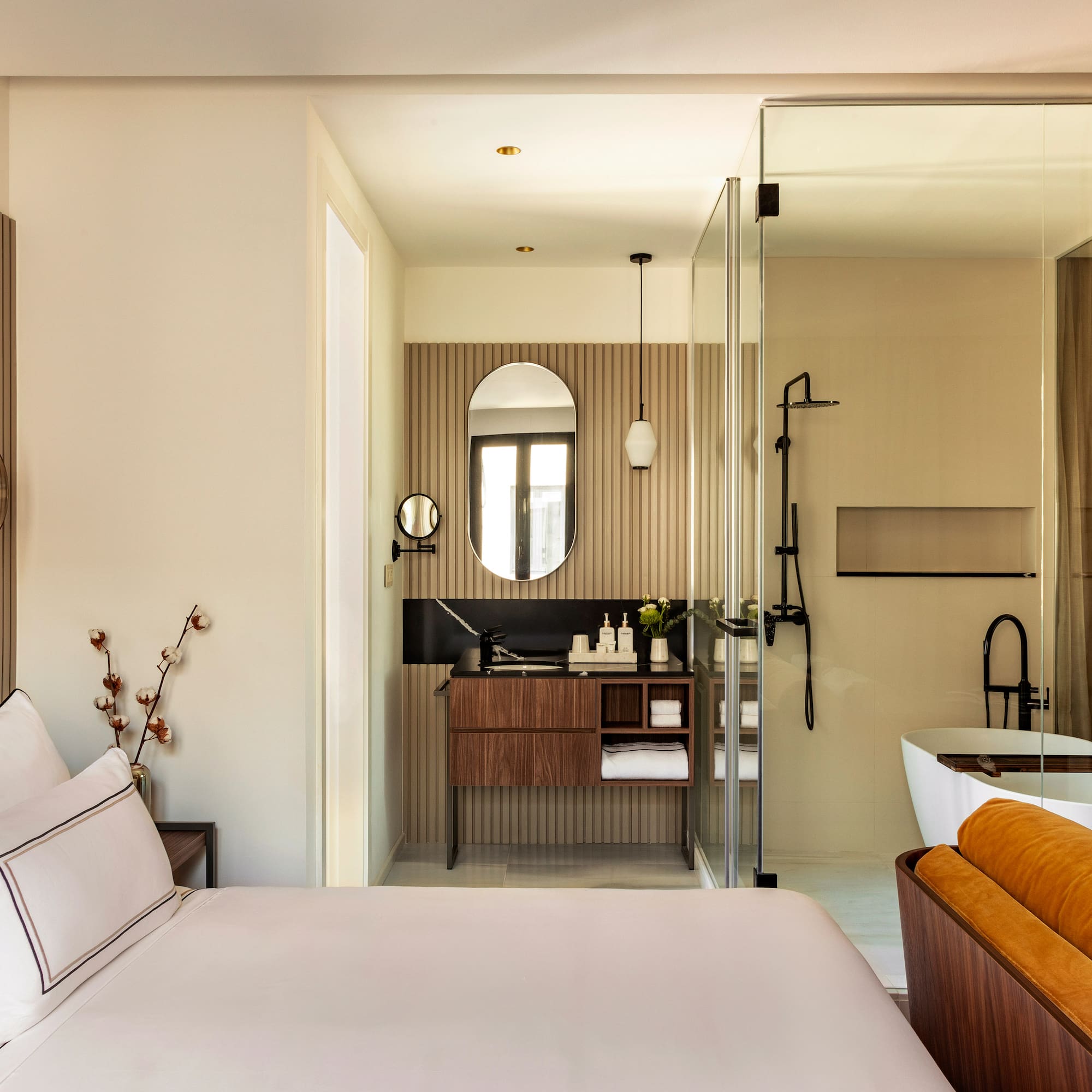 a bedroom with a glass shower door and a bed